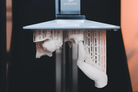 Close-up of a resin 3D printer building a part